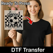 A smiling woman holding a sign with a soccer ball and the text "Soccer Mama" on it.