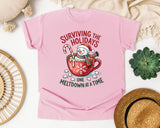 Surviving the Holidays One Meltdown at a Time graphic tee in Blossom Comfort Colors 1717